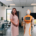 This image features a woman standing next to a humanoid robot in a modern laboratory