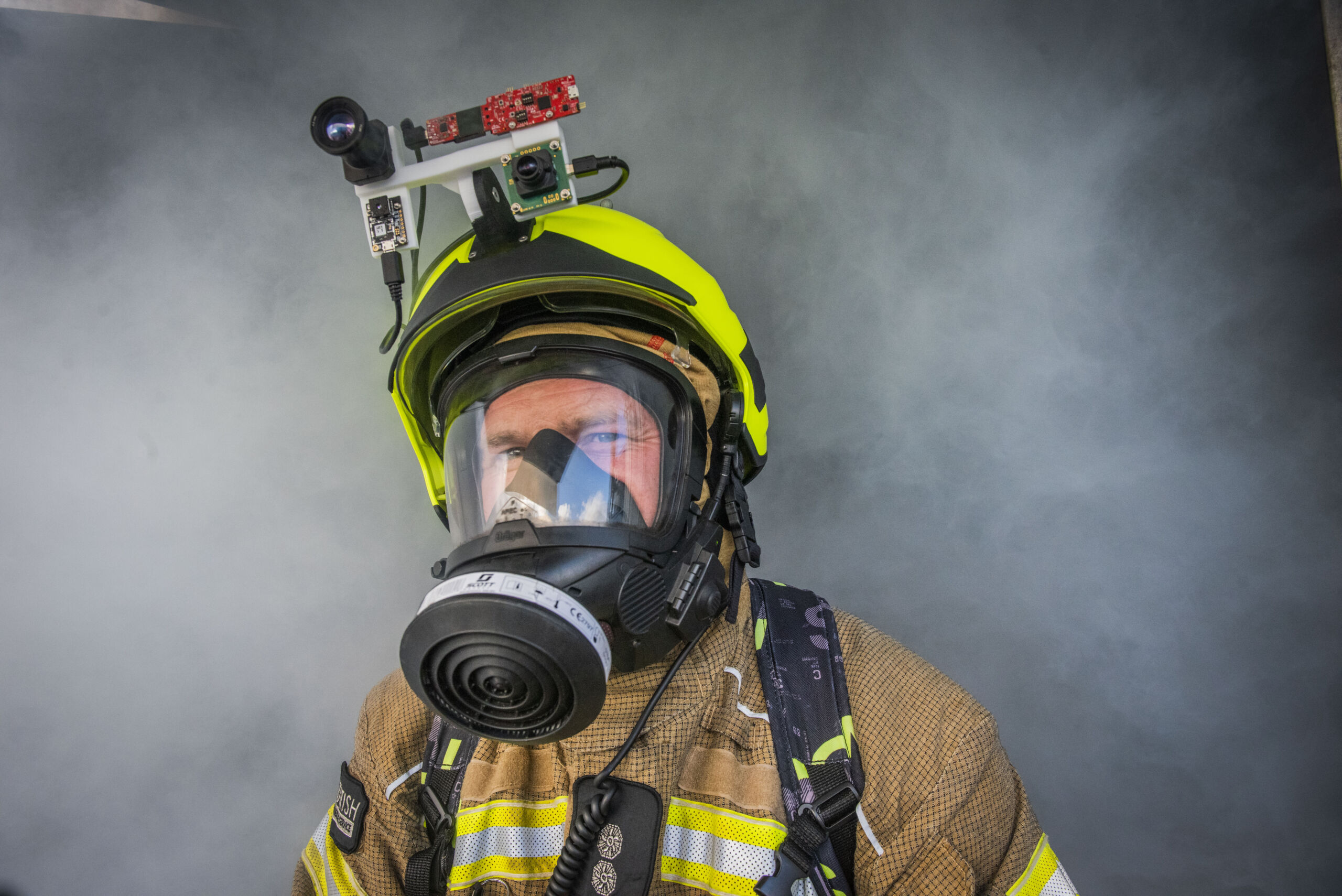 A firefighter moves through smoke with smart AI-fitted helmet
