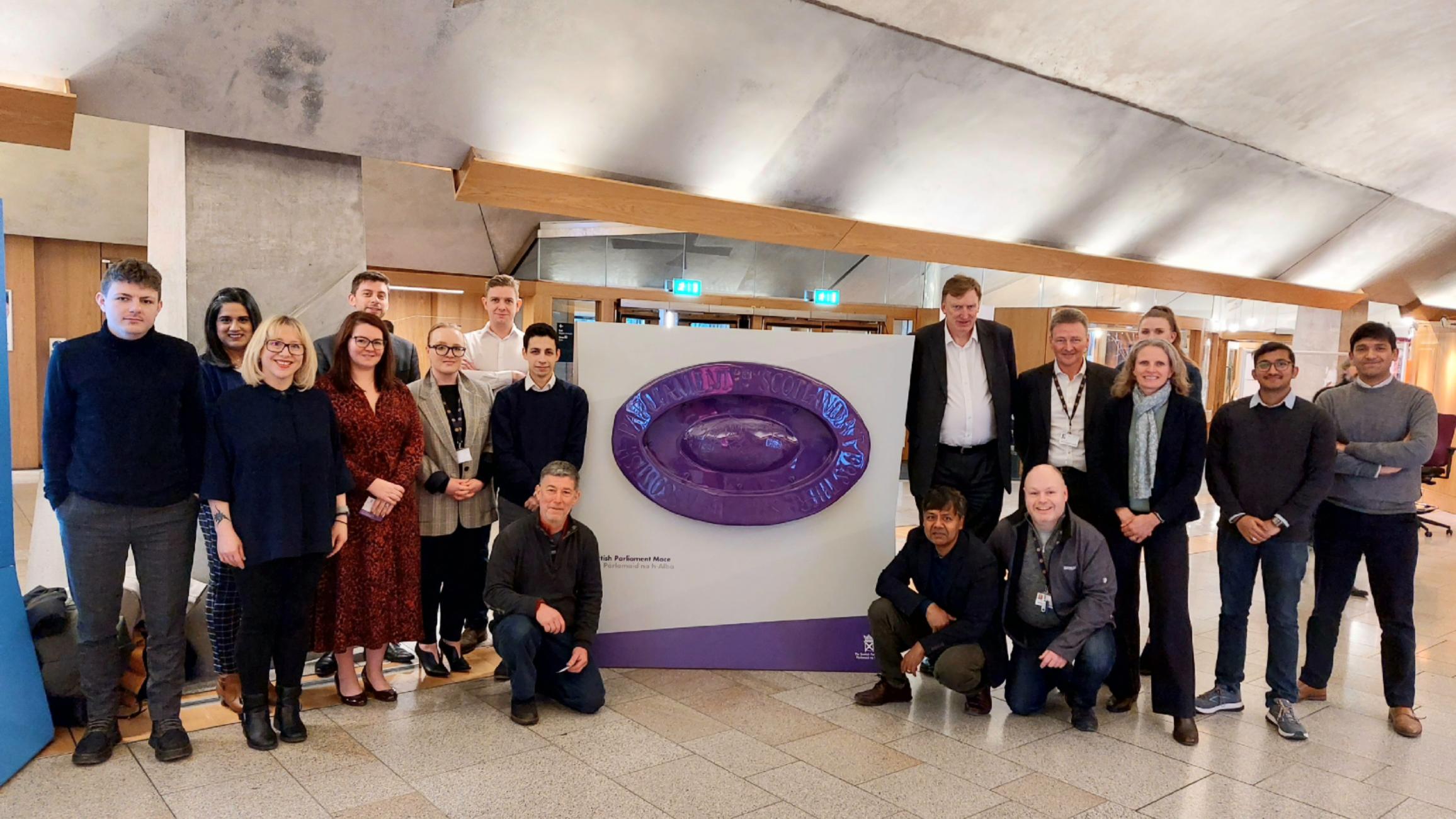 A group of people standing inside a building foyer